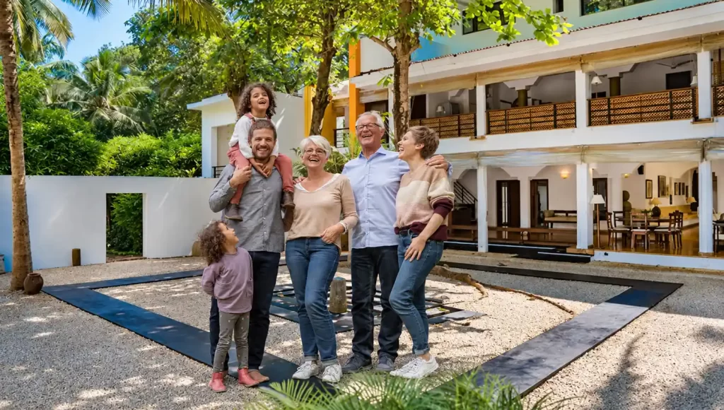 Happy extended family standing in garden of Villa Aashyana